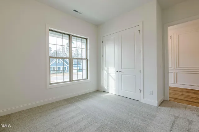 a view of an empty room with a floor to ceiling window
