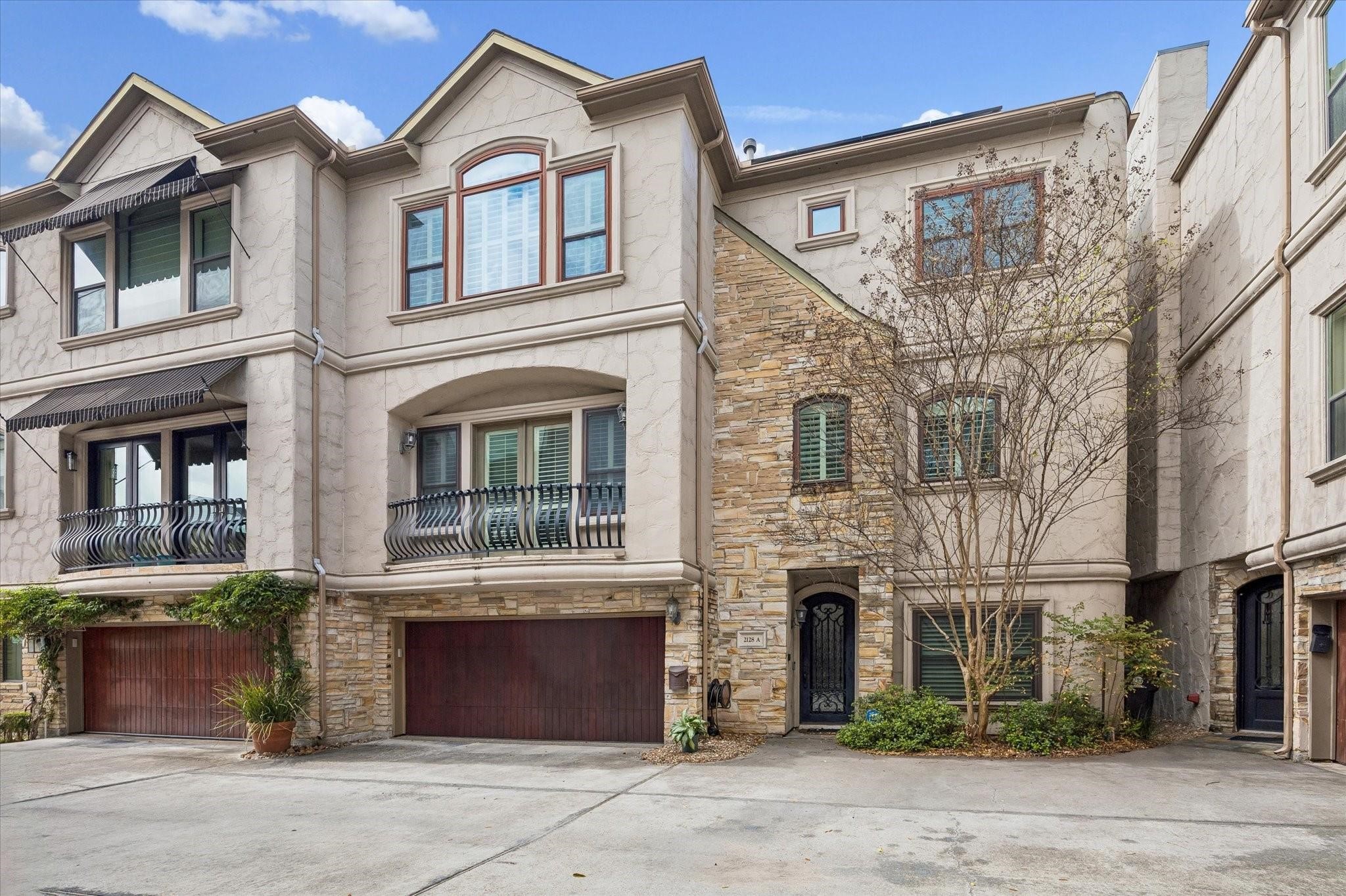 2128 Harold Street, Unit A Houston, TX 77098 - Photo 1 of 14 a front view of a house with a yard