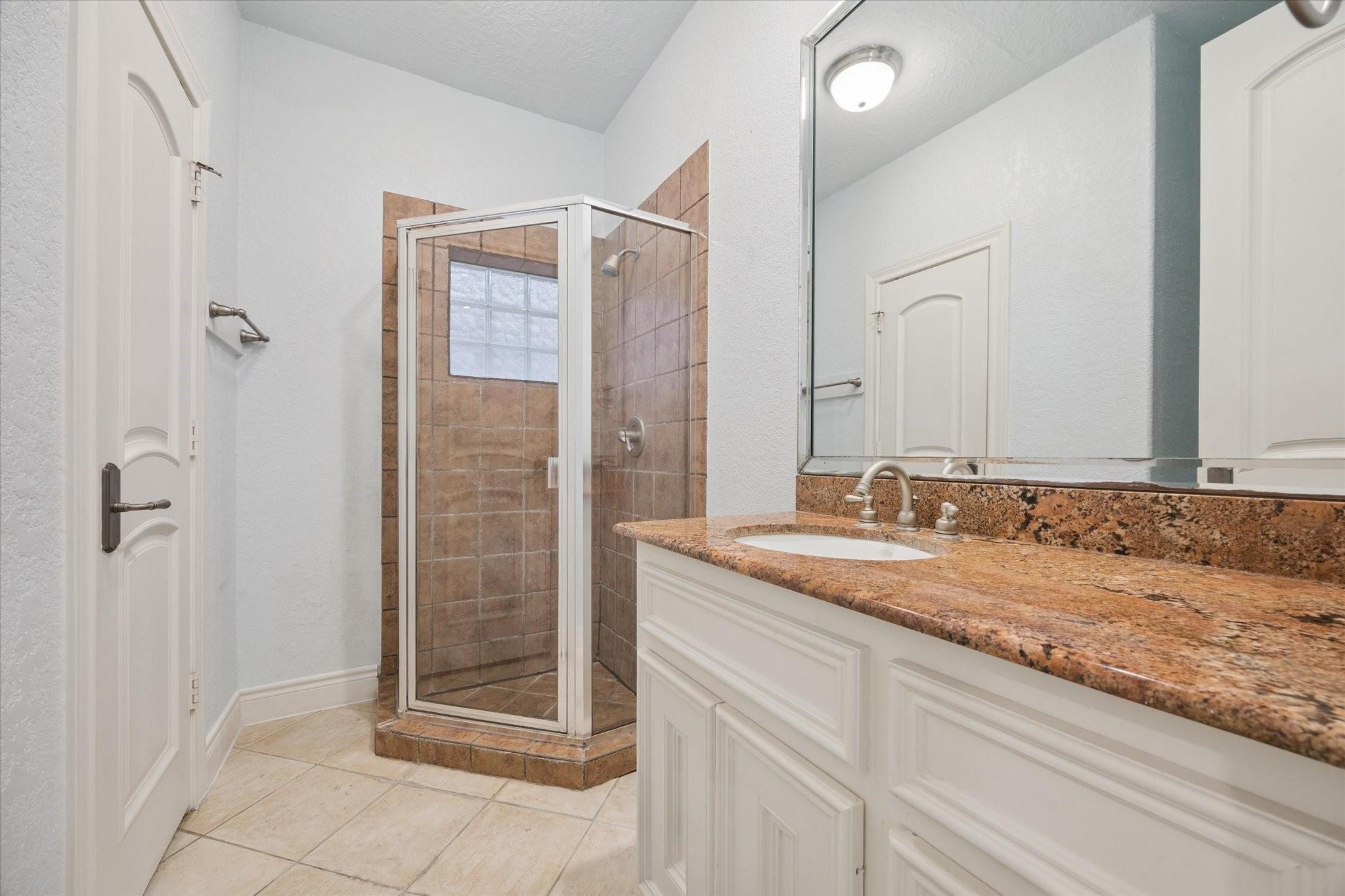2128 Harold Street, Unit A Houston, TX 77098 - Photo 11 of 14 a bathroom with a granite countertop sink and a mirror