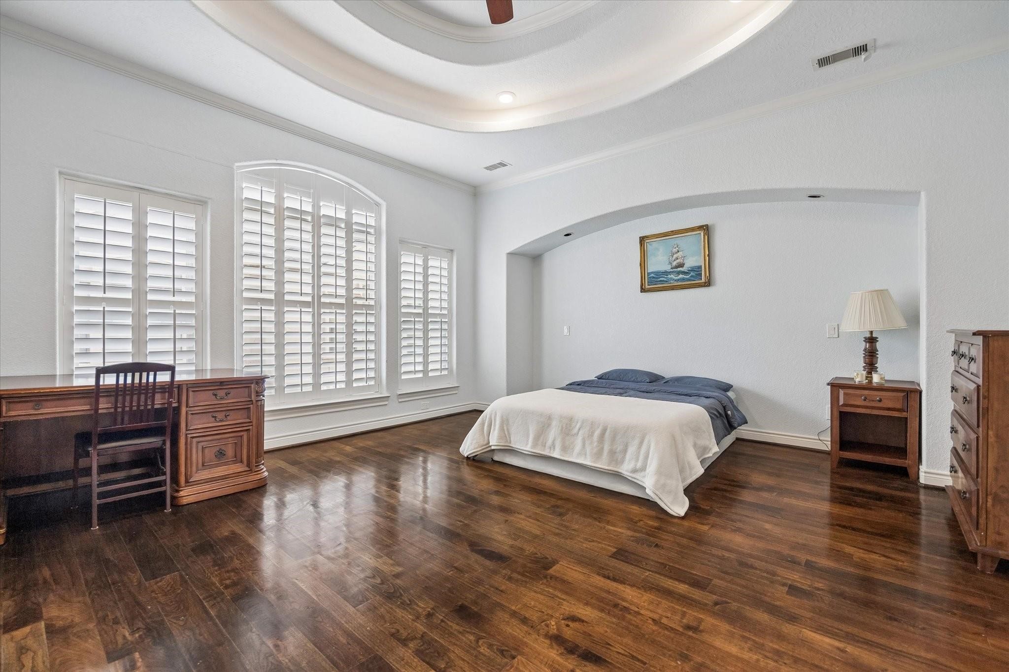 2128 Harold Street, Unit A Houston, TX 77098 - Photo 5 of 14 a spacious bedroom with a bed and wooden floor