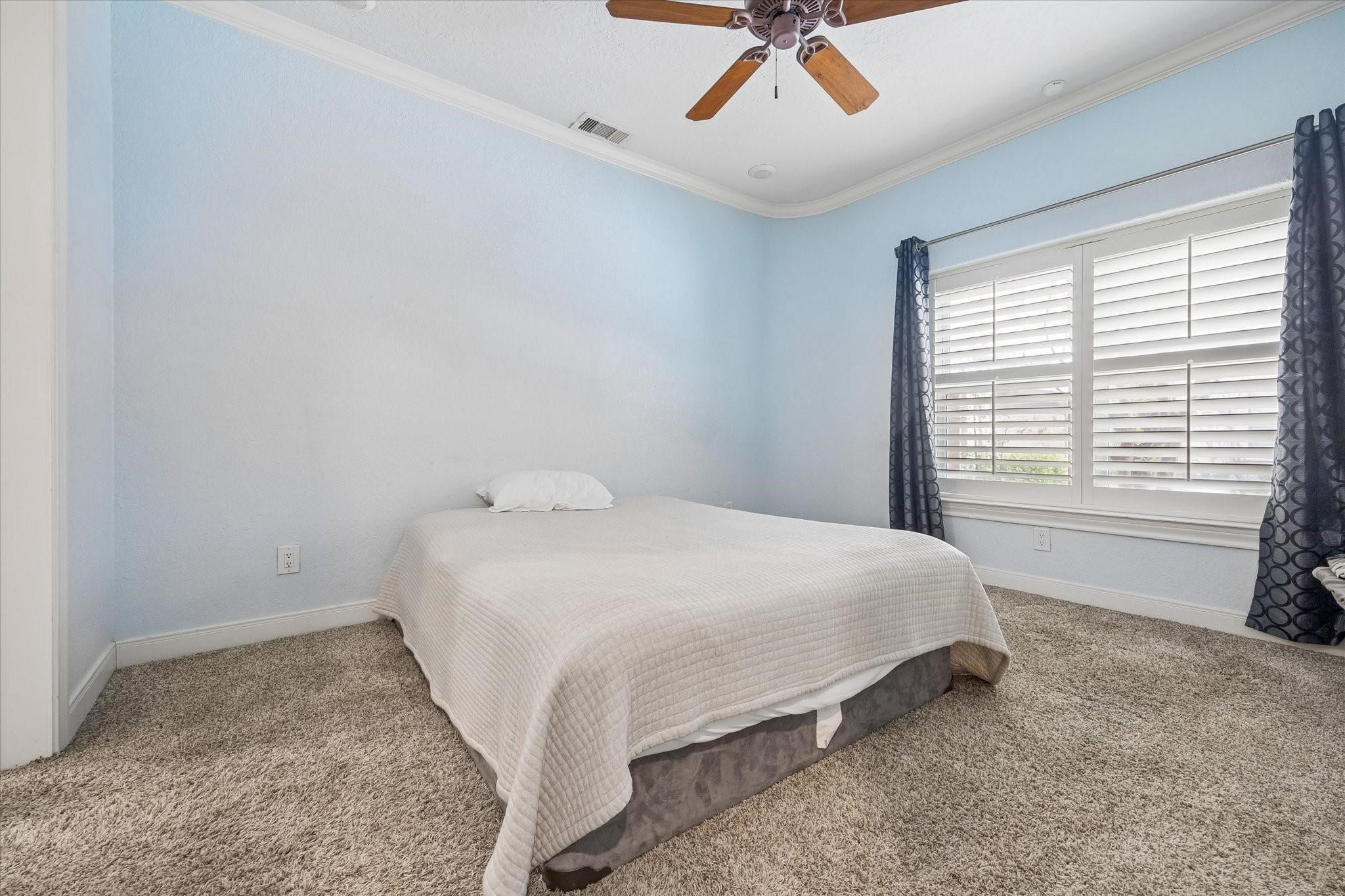 2128 Harold Street, Unit A Houston, TX 77098 - Photo 8 of 14 a bed sitting in a bedroom next to a window