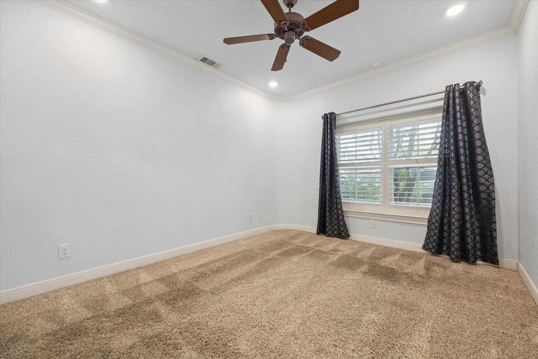 2128 Harold Street, Unit A Houston, TX 77098 - Photo 10 of 14 a view of a room with a ceiling fan and a window