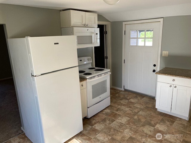 547 South Sullivan Street Seattle, WA 98108 - Photo 12 of 17 a white refrigerator freezer and a stove sitting inside of a kitchen