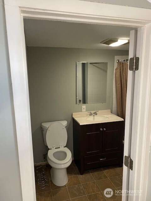 547 South Sullivan Street Seattle, WA 98108 - Photo 15 of 17 a bathroom with a sink and a mirror