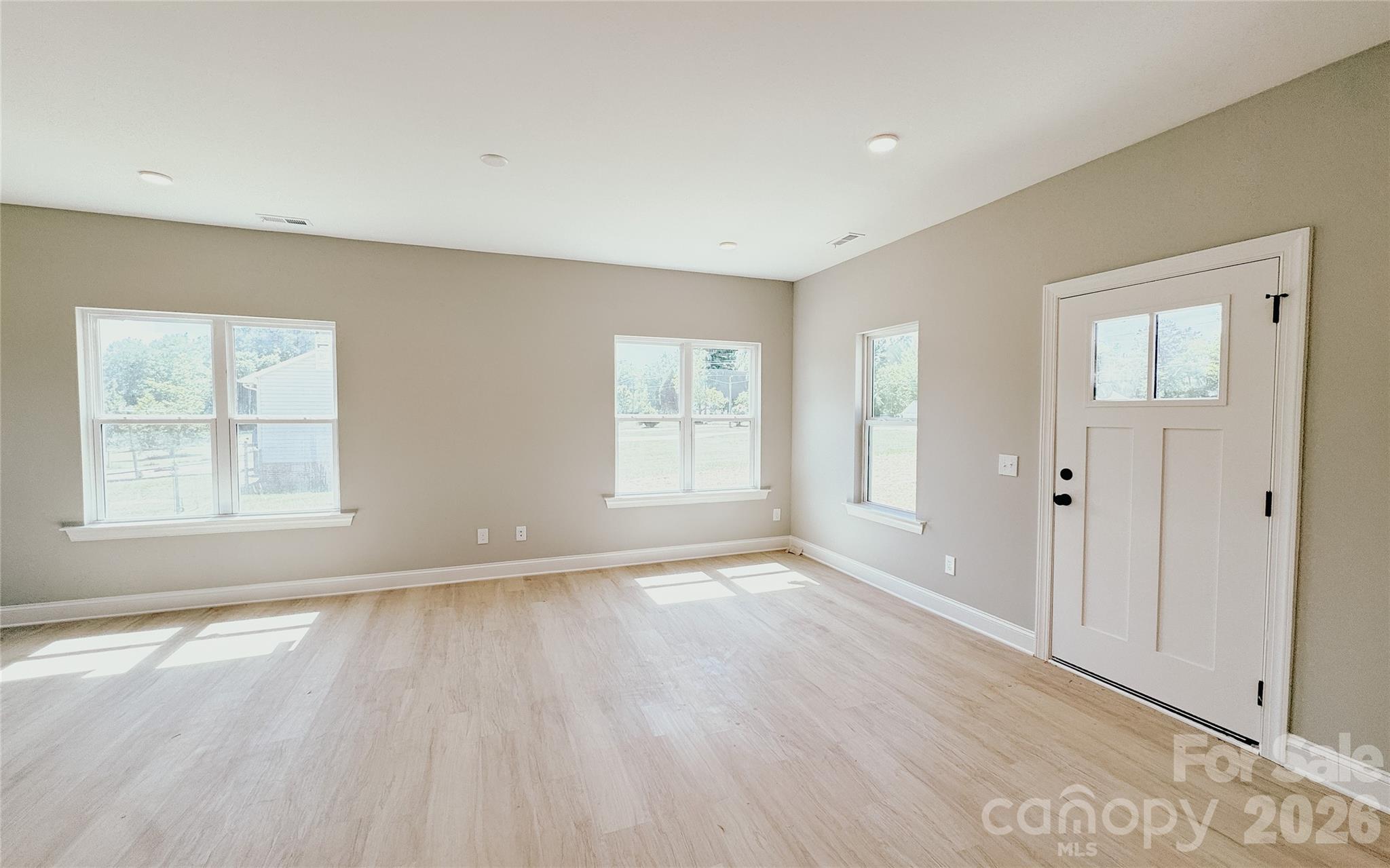 1455 West Ridge Road Salisbury, NC 28147 - Photo 7 of 26 an empty room with wooden floor and windows