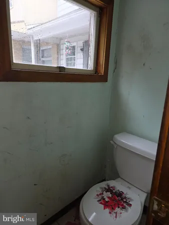 a bathroom with a toilet and a window