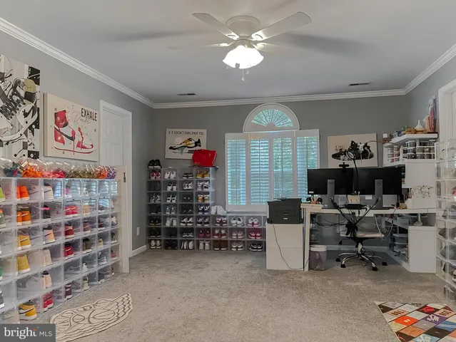 a view of a livingroom with workspace and a window