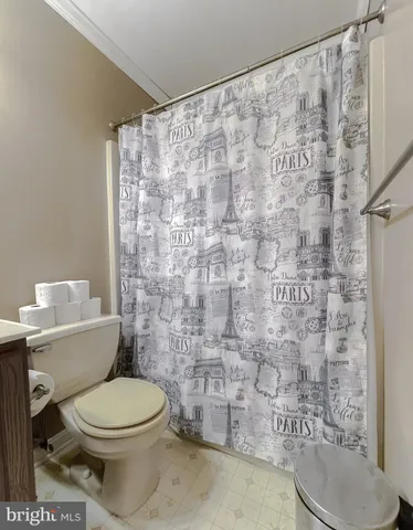 a spacious bedroom with a bed and a chandelier