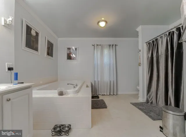 a view of a workspace with furniture and a flat screen tv