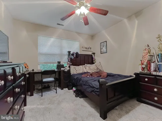 a bathroom with a toilet and a shower curtain