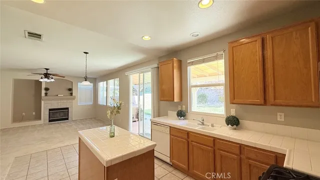 a kitchen with stainless steel appliances granite countertop a stove a microwave and a sink