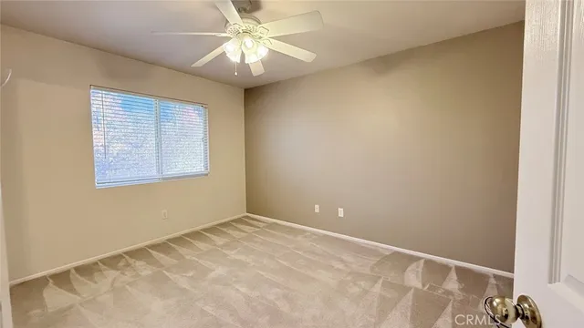 an empty room with closet and a bathroom