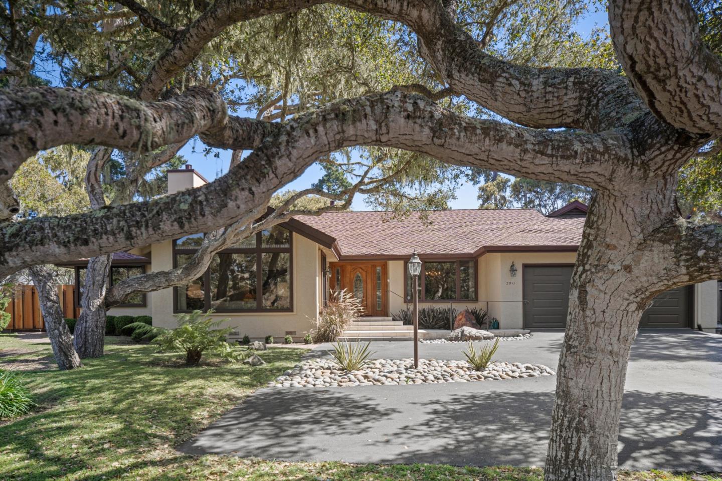 2911 Colton Road Pebble Beach, CA 93953 - Photo 3 of 46 a front view of a house with a tree
