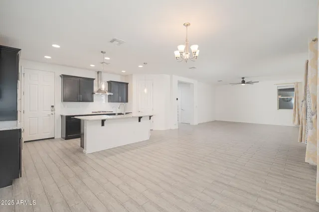 a large kitchen with kitchen island a sink stainless steel appliances and cabinets