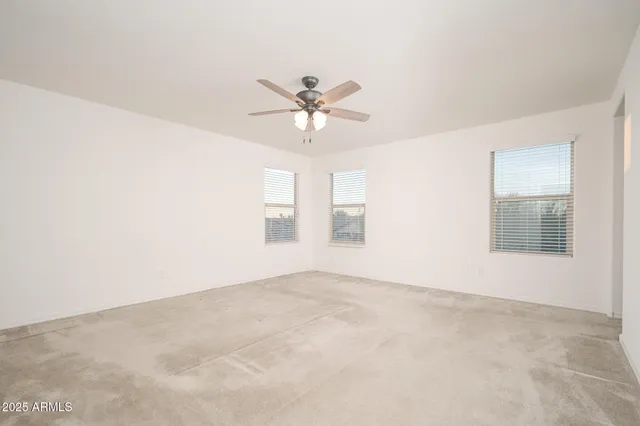 a view of a room with a ceiling fan and a chandelier fan