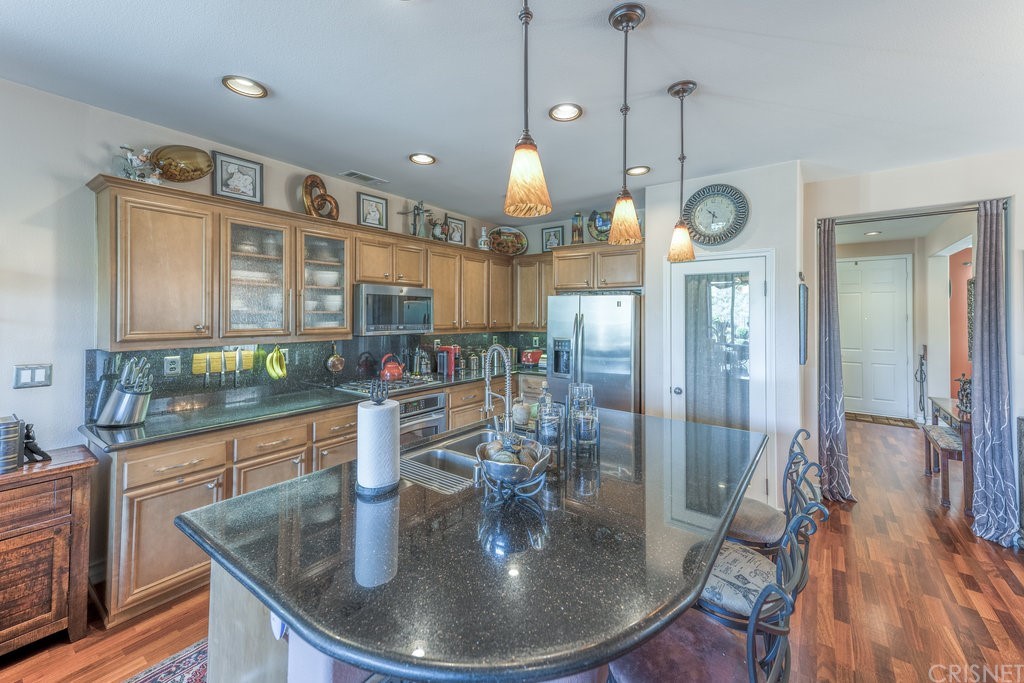 29021 Mirada Circulo Valencia, CA 91354 - Photo 12 of 57 a dining room with furniture a chandelier and wooden floor