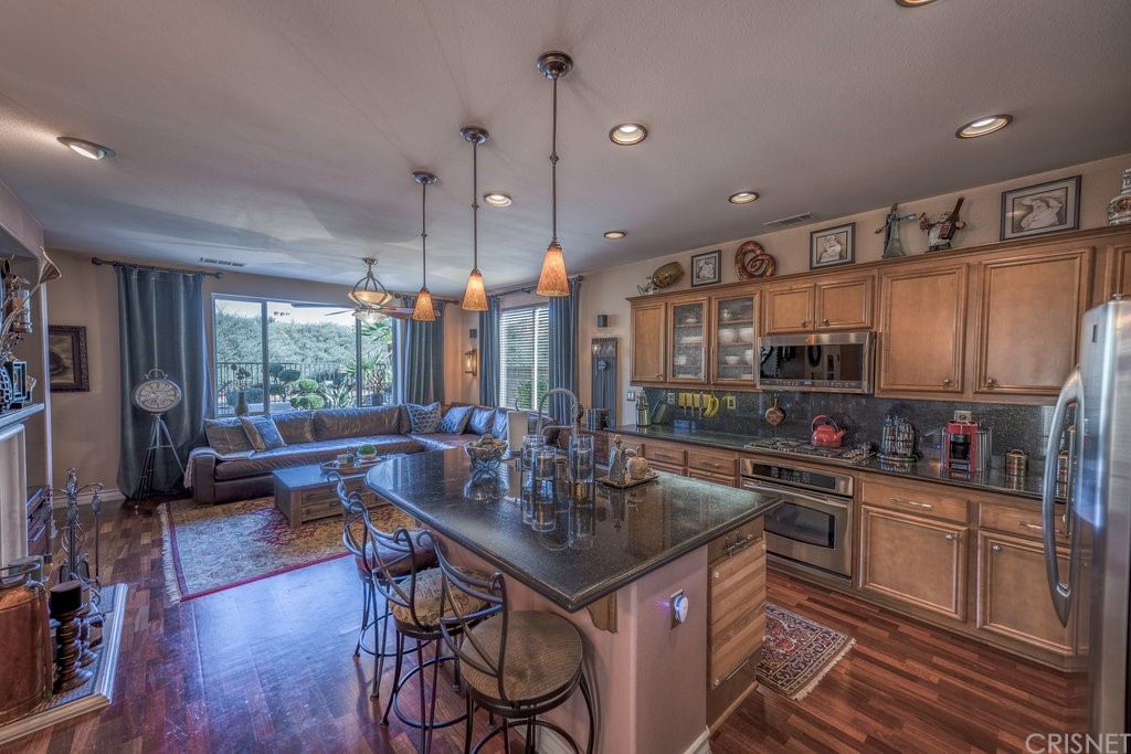 29021 Mirada Circulo Valencia, CA 91354 - Photo 14 of 57 a kitchen with stainless steel appliances granite countertop a sink a stove and a wooden floors