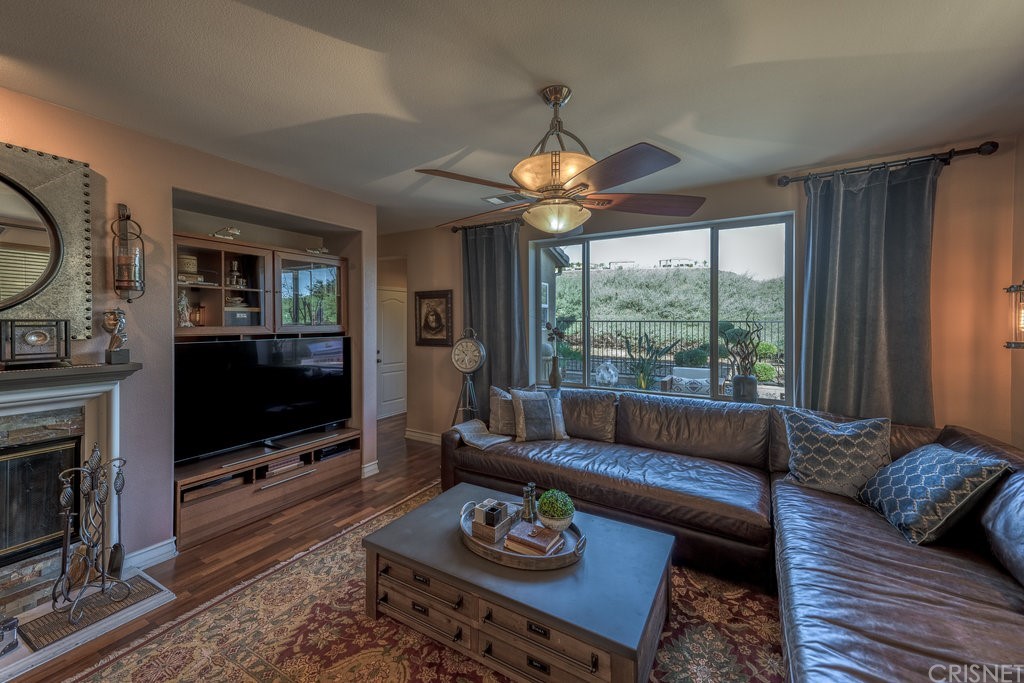 29021 Mirada Circulo Valencia, CA 91354 - Photo 15 of 57 a living room with furniture a flat screen tv and a floor to ceiling window