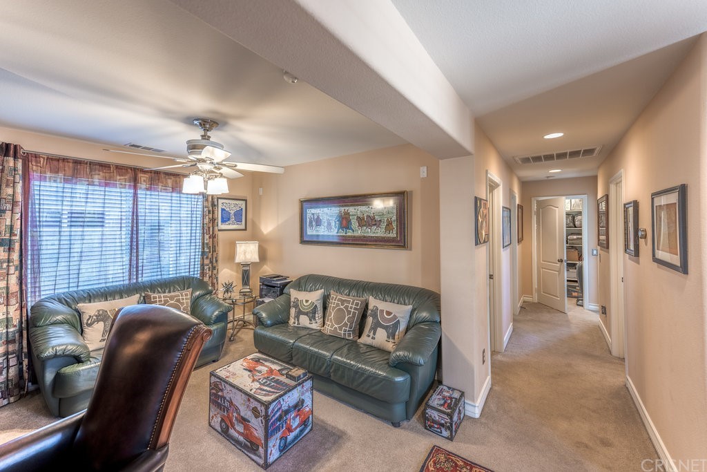 29021 Mirada Circulo Valencia, CA 91354 - Photo 30 of 57 a living room with furniture and a chandelier