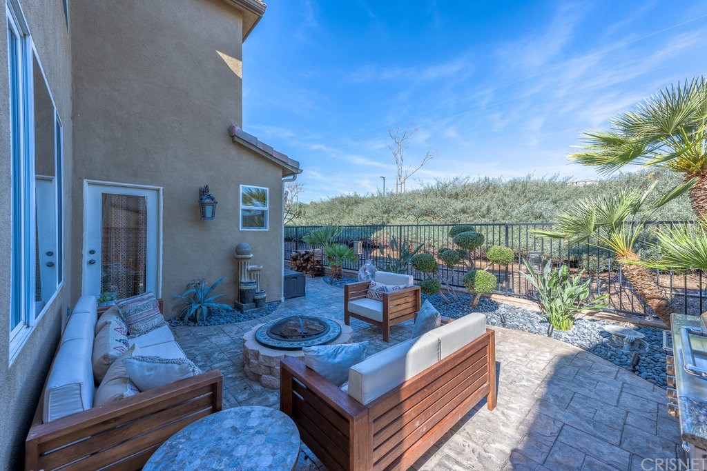 29021 Mirada Circulo Valencia, CA 91354 - Photo 41 of 57 a view of a patio with couches chairs and a potted plant