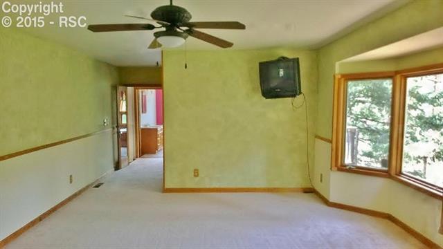 5350 Rampart Terrace Road Cascade, CO 80809 - Photo 1 of 7 Spacious master bedroom with ceiling fan, wall tv, and bay window overlooking the pines. New carpet!