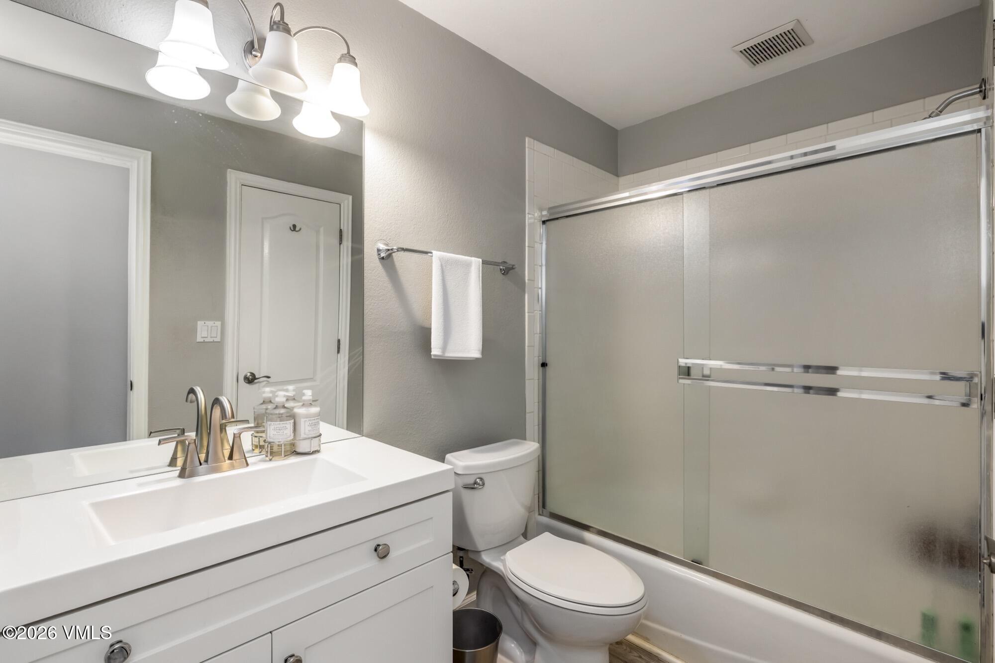 1671 Winslow Road Edwards, CO 81632 - Photo 44 of 48 a bathroom with a sink a mirror a toilet and shower