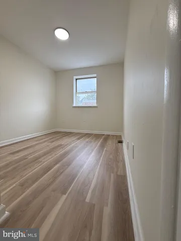 a view of room with wooden floor and window