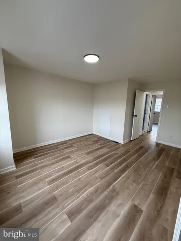 a view of empty room and wooden floor