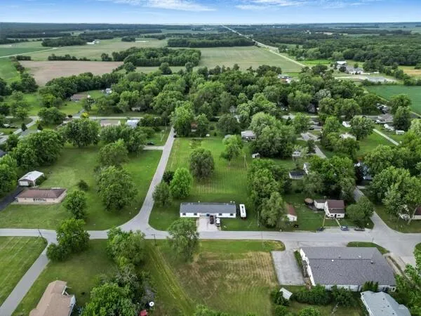 an aerial view of a houses with a yard