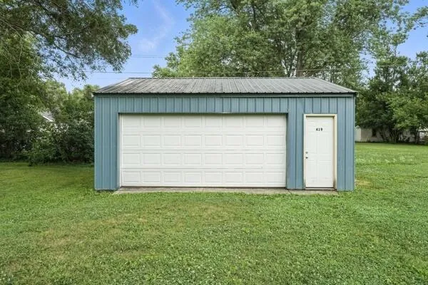 a view of backyard of house with green space