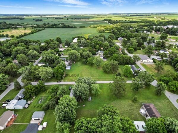 419 Clay Street Morocco, IN 47963 - Photo 5 of 15 an aerial view of green landscape with trees houses and lake view