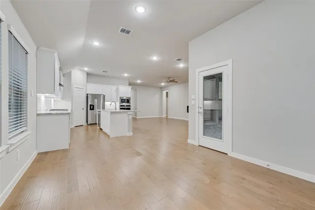 a view of kitchen with kitchen island and stainless steel appliances