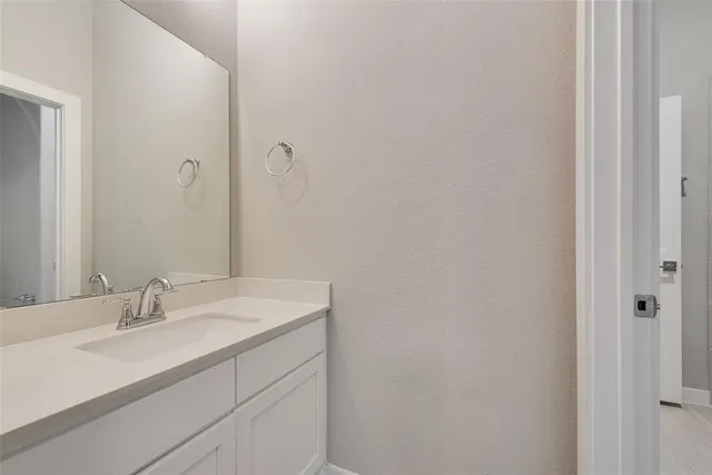 a bathroom with a sink vanity and a mirror