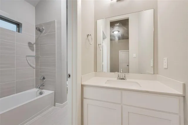 a bathroom with a bathtub a sink and a mirror