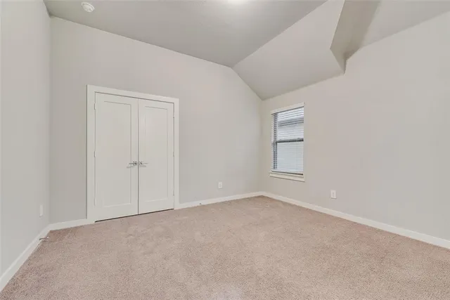 a view of an empty room and a window