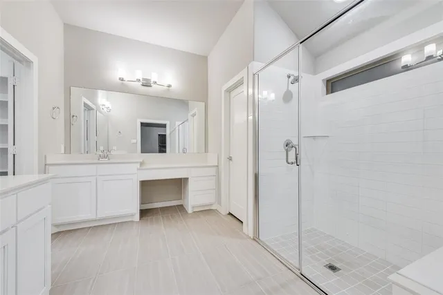 a bathroom with a double vanity sink mirror and shower