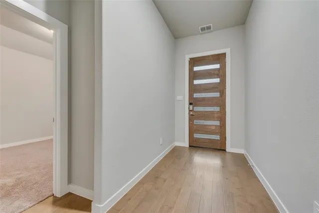 a view of a room with wooden floor