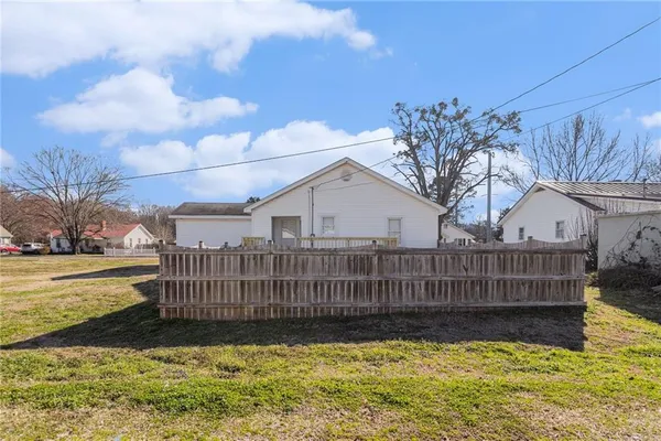 a view of a house with a wooden fence