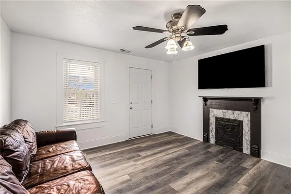 a living room with furniture a fireplace and a flat screen tv
