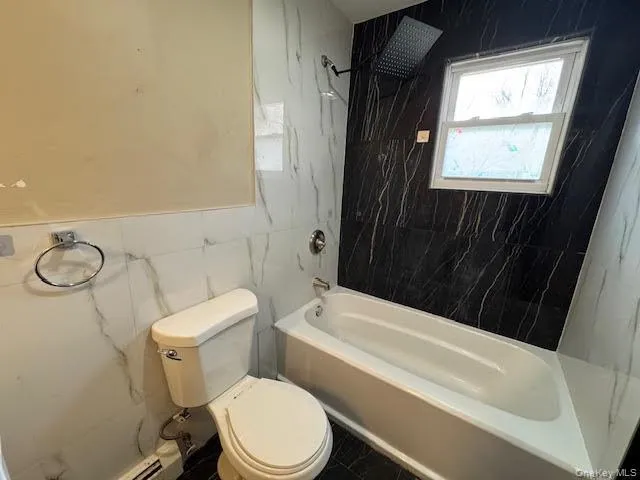 a bathroom with a toilet a sink and bathtub