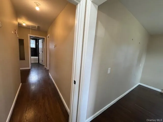 an empty room with wooden floor and closet