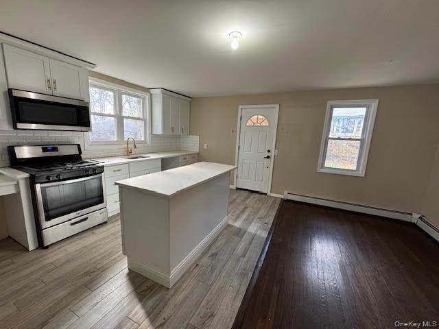 177 Riley Road New Windsor, NY 12553 - Photo 5 of 39 a kitchen with a sink stove and wooden floor