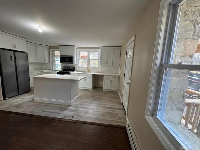 177 Riley Road New Windsor, NY 12553 - Photo 7 of 39 a view of a kitchen with a sink refrigerator and wooden floor