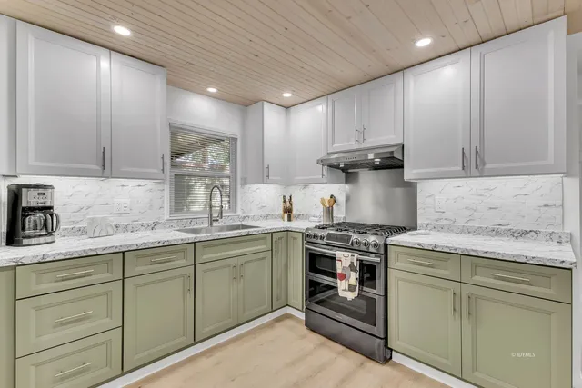 a dining room with stainless steel appliances granite countertop furniture and a kitchen view