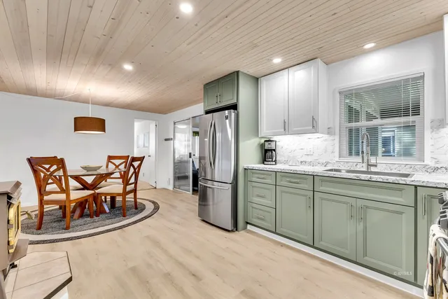 a bedroom with a bed and a flat tv screen on dresser