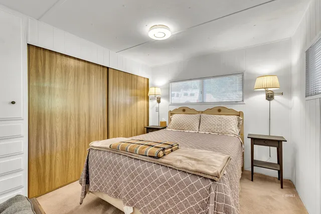 a bathroom with a granite countertop sink and a bathtub