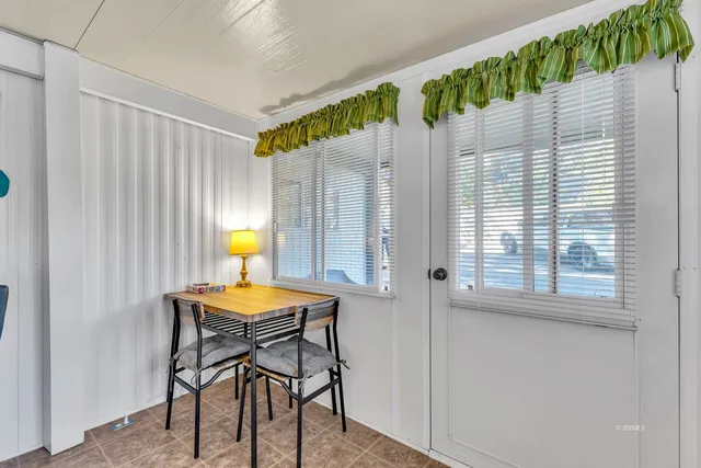 a dining room with furniture and a chandelier