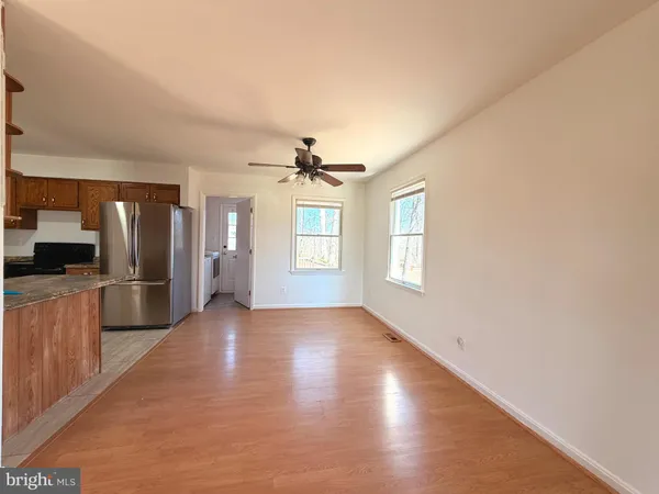 a kitchen with stainless steel appliances granite countertop a refrigerator sink and stove