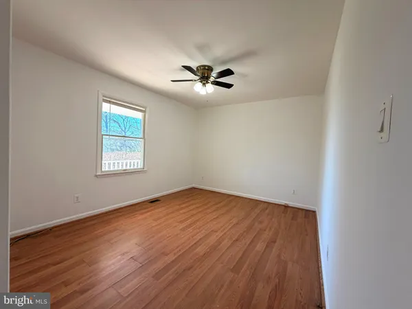 a view of hallway with wooden floor