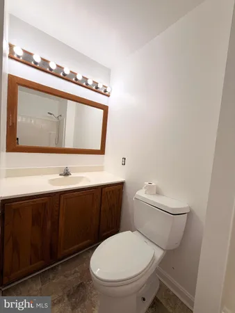 a white toilet sitting next to a bath tub